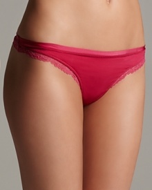 An ultra soft thong with delicate lace trim along hips and waist for a flattering silhouette.