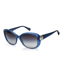 Sabrina follows one of the hottest trends of the season-cat eye.  This fashionable look by Coach is in blue with grey, gradient lenses or dark green with green, gradient lenses. The popular C disc configuration at the temples originates from the iconic pattern featured on best-selling Coach handbags. A Coach Signature grommet is at the end of each temple tip. Coach lenses provide 100% UV protection.