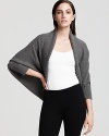 A sumptuous layer for the fashion savvy, this Donna Karan New York cashmere shrug lends polish to your every day look.