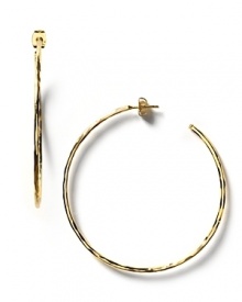 These large wavy hoop earrings have a hammered texture which lends a subtle shimmer.