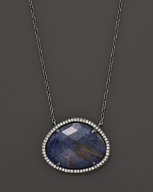 Diamonds circle a faceted rutilated quartz and blue sodalite doublet set in blackened sterling silver. By Di Massima.