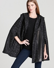 DIANE von FURSTENBERG puts a hyper-modern spin on the classic cape silhouette with a rich lamb leather panel.