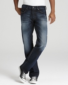 A relaxed fit jean with a deep blue rinse and contrast sandblast fading along the leg and seat.