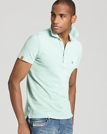 Crafted in ultra-soft pique cotton, this handsome slim fit polo earns a place in your essential warm-weather wardrobe.