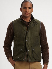 Utility pockets and a rugged oilcloth construction imbue this vest with an authentic look and feel.Full-zip frontSnap button placketStand collarChest slash, waist flap pocketsAbout 27 from shoulder to hemCottonDry cleanImported