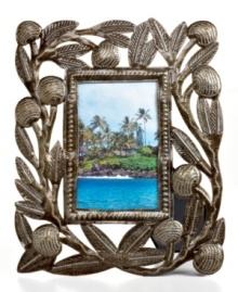 Carved with the bounty of Haiti's all-important breadfruit tree, this hand-cut and hammered picture frame tells a unique story in cleverly re-purposed steel.