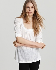 Rendered in airy linen, this white Joie top is summer's update to the laidback tee. Raglan sleeves that roll and tab up with button closures keep things casual, while a fluid silhouette lends chic.