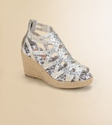 Lustrous metallic fabric in a graphic cutout pattern is sprinkled with sparkling rhinestones and sits atop a rope-covered wedge.Metallic microsuede fabric upperRhinestone accentsBack zipper for easy on and offRope-covered wedgePadded insoleComposite rubber solePrint faux leather liningImported