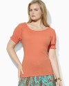 Imbued with breezy bohemian style, a soft cotton jersey top gets a romantic update with a smocked neckline and cuffs.