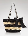 kate spade gives the classic tote an on trend update in textured woven raffia. Boasting a grosgrain bow and striped silhouette, it's a bold shoulder statement.