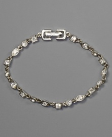 A stunning bracelet with crystal accents in an array of shapes, by Givenchy. Set in silvertone mixed metal. Approximate length: 7-1/4 inches.