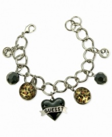 For the wild at heart, this charm bracelet from GUESS is crafted from silver-tone mixed metal with jet and glass crystal accents bringing a stylish edge. Leopard print enhances the animal attraction. Item comes packaged in a signature GUESS Gift Box.  Approximate length: 7-1/2 inches. Approximate drop: 1 inch. Approximate diameter: 1-1/2 inches.