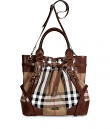 Whether paired with casual looks or an early evening cocktail ensemble, make a bold statement in this luxe, logo-laden tote from Burberry London - Classic carryall style, leather carrying handles and convertible shoulder strap, leather trim detailing and multiple straps, logo printed body, metal feet at bottom, multiple internal pockets- Perfect for daily use or off-duty chic