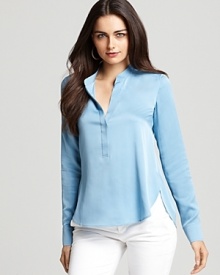 In a tranquil shade of blue, this chic Vince blouse softens the look of crisp denim with a soft rounded hem and femme back pleats. Made of luxe stretch silk, the silhouette holds its shape beautifully, making it a worthy investment piece.