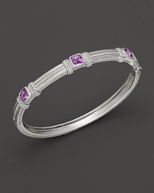 Intricately textured silver provides a dramatic backdrop for three cushion cut amethysts. By Judith Ripka.