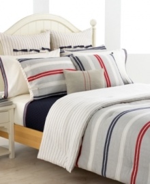 Classic, American, fun! Featuring a yarn-dyed herringbone and twill weave finished with navy pompoms at the corners, this decorative pillow accents your bed with signature Tommy Hilfiger style.