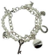 GUESS doubles the style factor with this two-row charm bracelet. Crafted from silver-tone mixed metal, the bracelet pops with glass pearls and crystal accents. Item comes packaged in a signature GUESS Gift Box. Approximate length: 7-1/2 inches long. Approximate diameter: 1-1/2 inches. Approximate drop: 1/2 inch.