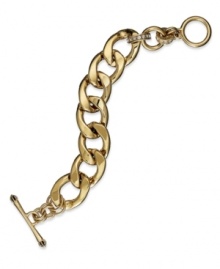 Golden links in a chunky design create huge style on this Juicy Couture bracelet. With a toggle closure and single cubic zirconia stone. Chain crafted of gold tone stainless steel. Approximate length: 7-1/2 inches.