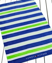 Lime green and blue stripes make a bold statement in this Cabana stripe beach towel, perfect for a relaxing day at the beach. Finished with the Tommy Hilfiger logo at each end.