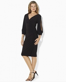 A bold V-neckline and split sleeves create an alluring dress, rendered in sleek matte jersey that flatters the figure.