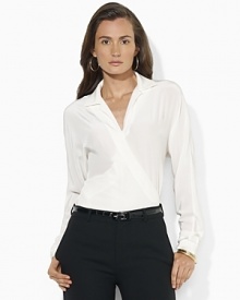 A soft silk wrap blouse is modernized for the season with dolman sleeves.