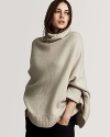 Soft cashmere poncho with turtleneck styling. By Burberry.