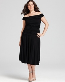 This tempting Melissa Masse dress starts with an alluring off-shoulder neckline that graduates into a fitted, ruched bodice, finishing in a flattering full midi skirt.