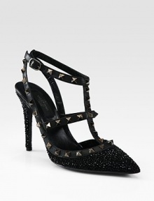 This signature t-strap pump goes uptown with glittery crystals, leather accents and edgy metal studs. Crystal-coated heel, 4¼ (110mm)Crystal coated fabric and leather upper with metal studsPoint toeAdjustable leather ankle strap with metal studsLeather lining and solePadded insoleMade in Italy