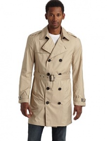 Lightweight and packable, this double breasted trench classic folds into itself and features water resistant fabric construction so you can brave the elements in style.Point collar with hook-and-eye Epaulettes Double breasted button front Single gun flap Long sleeves with belted cuffs Dual side pocketsBuckled belt Storm flap One inside zip pocket Fully lined About 35½ from shoulder to hem Polyester; hand wash Imported