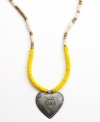 A strong heart. Strung with wooden beads and a hand-cut and hammered pendant, this Heart of Haiti necklace is crafted by a co-op that supports women's employment in local communities.