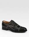 Black leather with antiqued gold cone-shaped stud hardware.Leather sole with micro GG rubber reinforcementMade in Italy