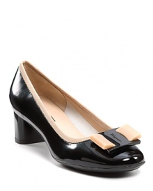 A flirty bow tops the toes of these demure black pumps, finished with nude grosgain trim. By Salvatore Ferragamo.