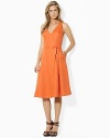 Breezy linen is the foundation of a classic sleeveless dress with a chic V neckline and self-belt waist.