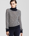 Transition into the new season with a wool Tory Burch sweater, featuring a jaunty stripe motif for preppy charm.