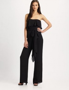 The contemporary jumpsuit gets a feminine touch in a filmy silk georgette flounceStraplessFlounce drapes from bodice to lower backSelf-beltWide legsInseam, about 44SilkDry cleanImported