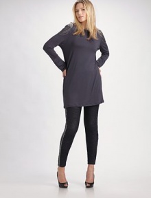 Luxe jersey knit has a hint of stretch and chic, chain-embellished shoudlers.Boatneck Long sleeves Back zipper Pullover style 97% viscose/3% spandex Dry clean Made in USA