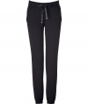 Perfect for pairing with sky-high heels, Juicy Coutures ultra comfy cuffed pants lends an edge of effortless feminine attitude to your outfit - Flat drawstring tie with gold-toned aglets, terry trimmed side slit pockets, fitted cuffs, sweatpant-style - Loosely fitted - Wear with a tee, boyfriend blazer and pumps