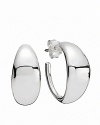 These sterling silver hoops in a modern shape go from everyday to elegant with ease. Earrings by PANDORA.