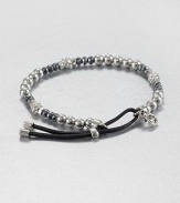 From the Brilliance Collection. A mix of silvery beads includes faceted hematite, smooth stainless steel and rhinestone-crusted spheres, strung on a stretchy strand with a leather slide close.HematiteGlassSilvertone and stainless steelLeatherDiameter, about 2.25Imported