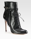 Channel biker-chic vibes wearing this leather ankle boot, with fringe detailing and an adjustable buckle strap. Self-covered heel, 4 (100mm)Leather upper with adjustable buckle strapLeather lining and solePadded insoleMade in Italy