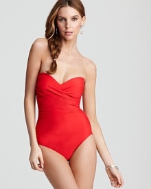 Reveal just the right amount of skin in this bandeau one piece from Miraclesuit. The one piece suit boasts crossbody rouching to create a plunge-perfect silhouette.