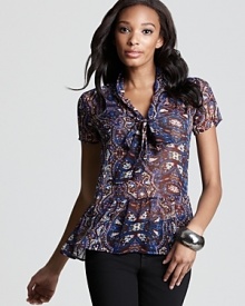 Bring a touch of bohemia to your look with this Aqua blouse in a pretty paisley print. A bow lends a feminine finish.