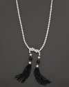 Freshwater pearls and onyx form a long, elegant lariat, ending in glamorous tassels.