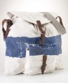 Steeped in nautical inspiration, a canvas bag is accented with rope details and distressed painted stripes.