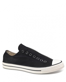 Slip-on Chucks with tongue sewn-in. Laceless-style with minimal construction. Eyelet detail across foot. Contrasting rubber sole.