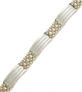 A luxurious blend of rich color and shine. Yell'Ora's men's bracelet features a thick link band that highlights three stations that highlight three rows of round-cut diamonds (1/2 ct. t.w.). Base metal made from a combination of pure gold, sterling silver and palladium. Approximate length: 8 inches.