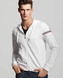 Casual gets a luxe touch with this white track hoodie from Moncler.