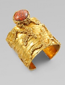 Like a piece of modern sculpture you'd find in a museum, this wide golden cuff combines the intriguing textures of tree bark and rough stone, capped by an oval glass cabochon with a mottled semiprecious look.GlassGoldtoneDiameter, about 2¼Made in Italy