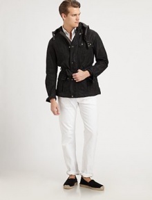 This modern iteration of a classic utility jacket is crafted from sleek waxed cotton, offering rugged style and water-repellent function.Zip frontSnap button placketAttached drawstring hoodChest and waist flap pocketsBelted waistFully linedAbout 31 from shoulder to hemCottonSponge cleanImported