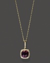 Diamonds frame a faceted amethyst, set in 14K yellow gold.